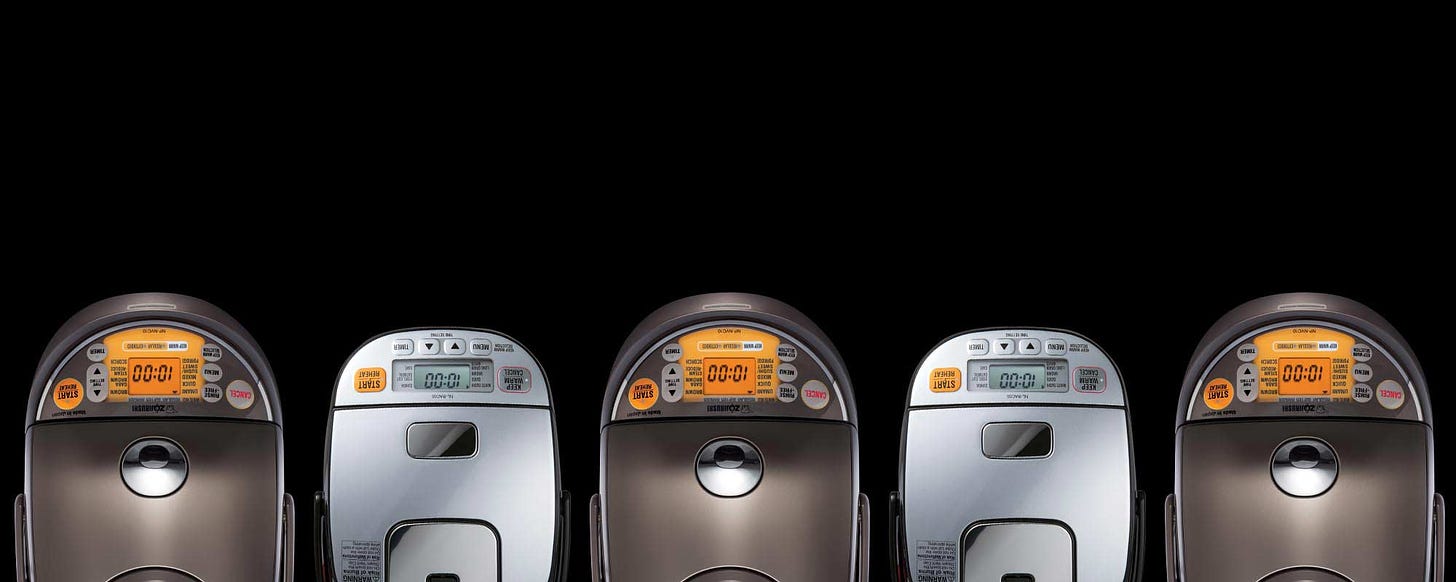 A birds-eye-view of Zojirushi rice cookers against a black background