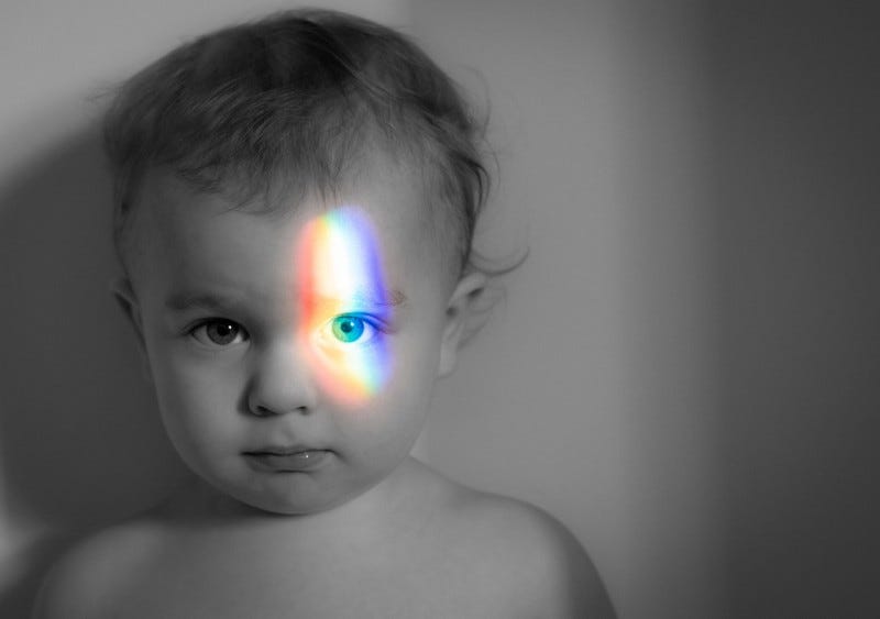Baby with prism light shining on eye.
