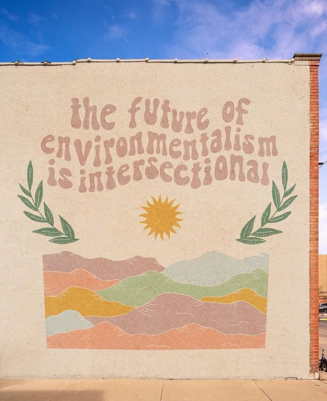 A painted wall that says 'the future of environmentalism is intersectional'