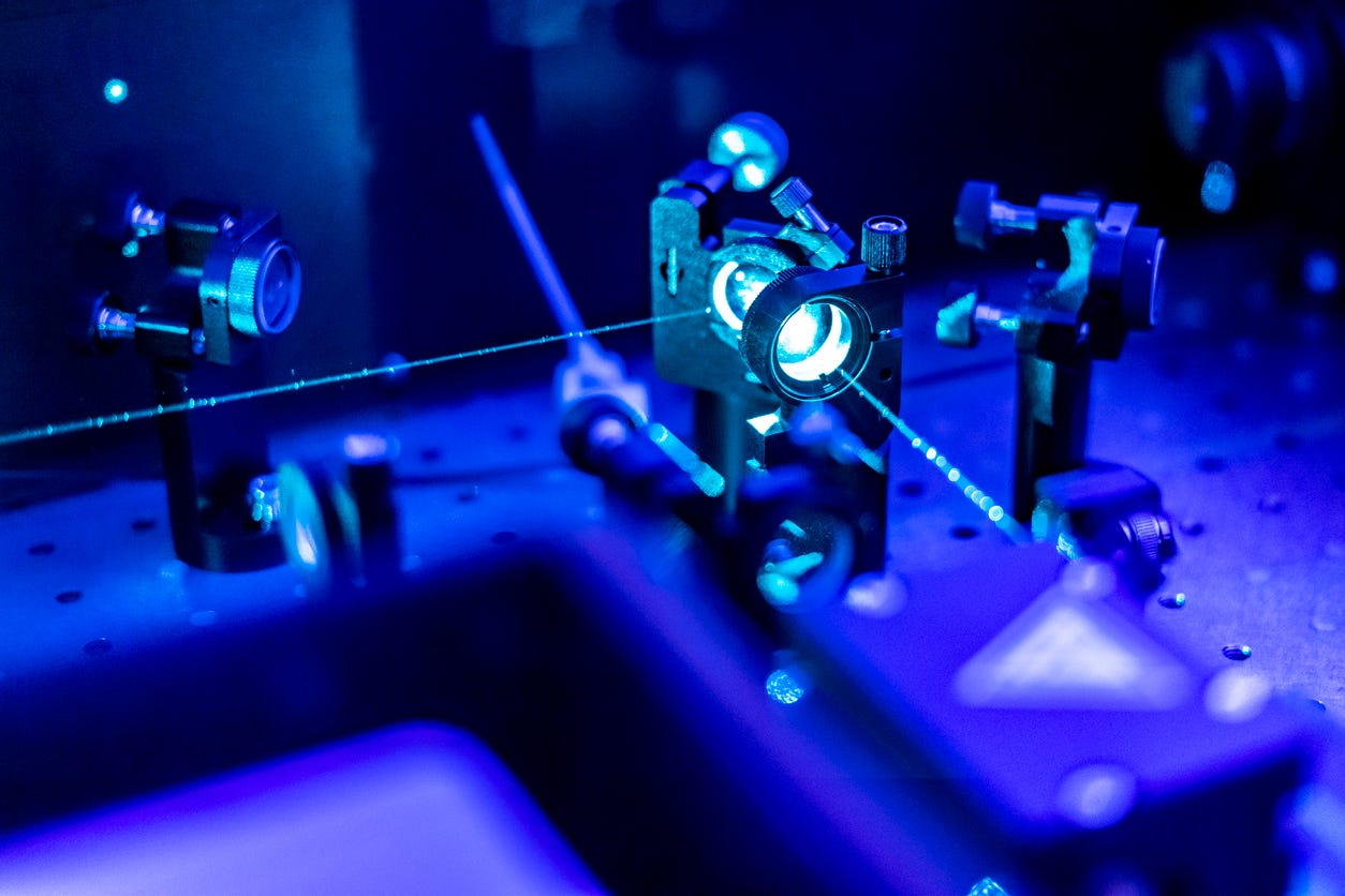 Laser reflect on optic table in quantum laboratory