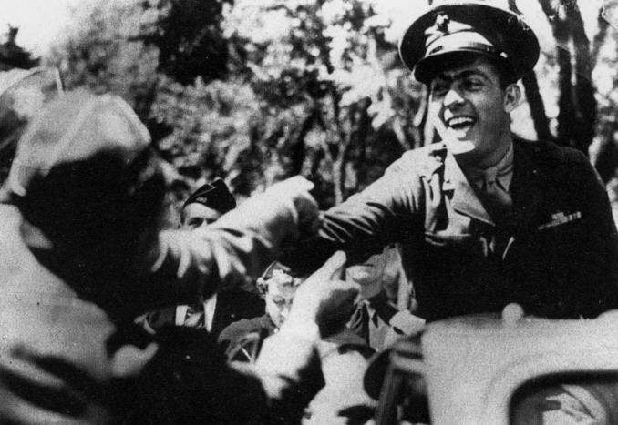 1943: John greets the crowd during a hometown parade in his honour.