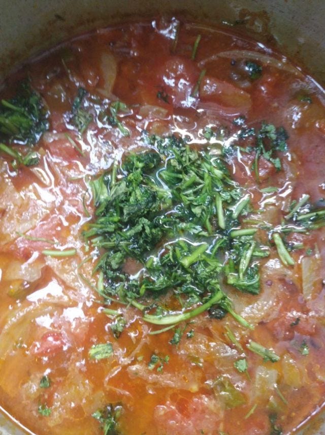 A vessel of tomatoes, onions and coriander on top.