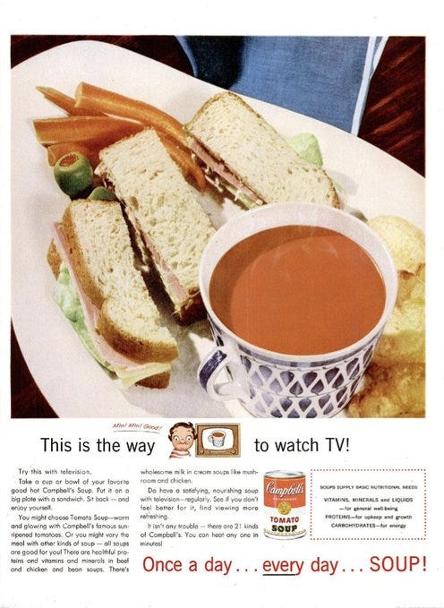 Ad for Campbell's soup showing a cup of tomato soup and a sandwich cut into three strips. The tagline is "once a day...every day...soup"