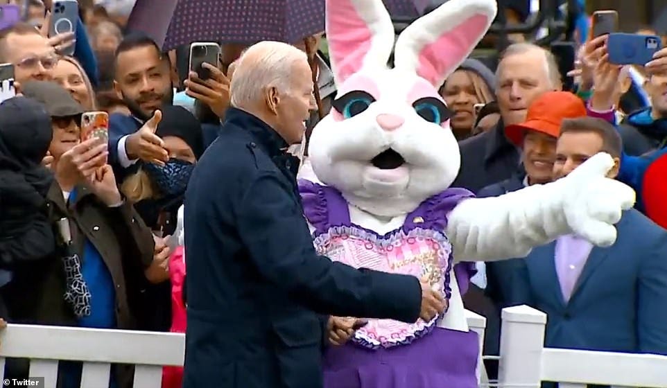 A person dressed as the Easter Bunny then points Biden in a different direction