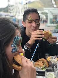 Young People Enjoying Burgers: Burger Yourself Happy courtesy of Face Book
