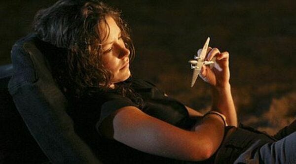 Kate Austen (Evangeline Lilly) holds a small toy plane. 