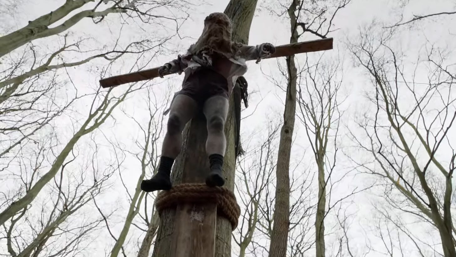 man hung on a tree crucifixion style