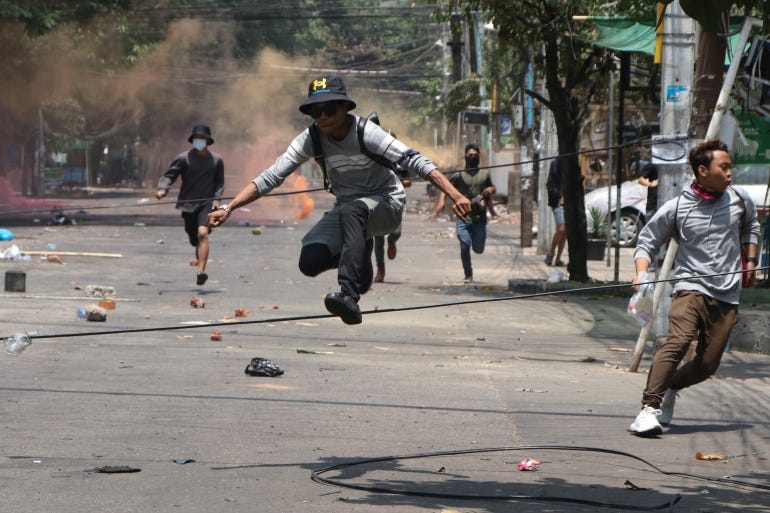 Anti-coup protesters run to avoid military forces during a demonstration in Yangon, Myanmar on Wednesday March 31, 2021 [File: AP]