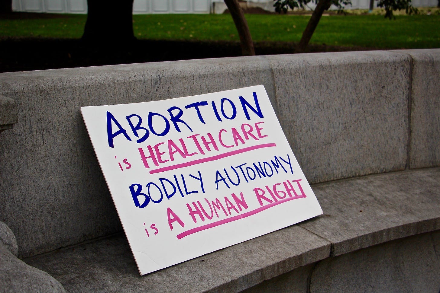 Pro-choice sign sitting on a bench outside the U.S. Supreme Court reading "abortion is healthcare bodily autonomy is a human right"