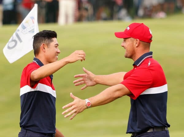 Collin Morikawa, left, and Bryson DeChambeau celebrated the Americans’ victory at the Ryder Cup.
