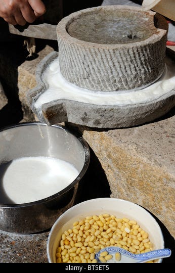 The traditional Chinese way of making soybean milk is to use a stone grain  grinder Stock Photo - Alamy