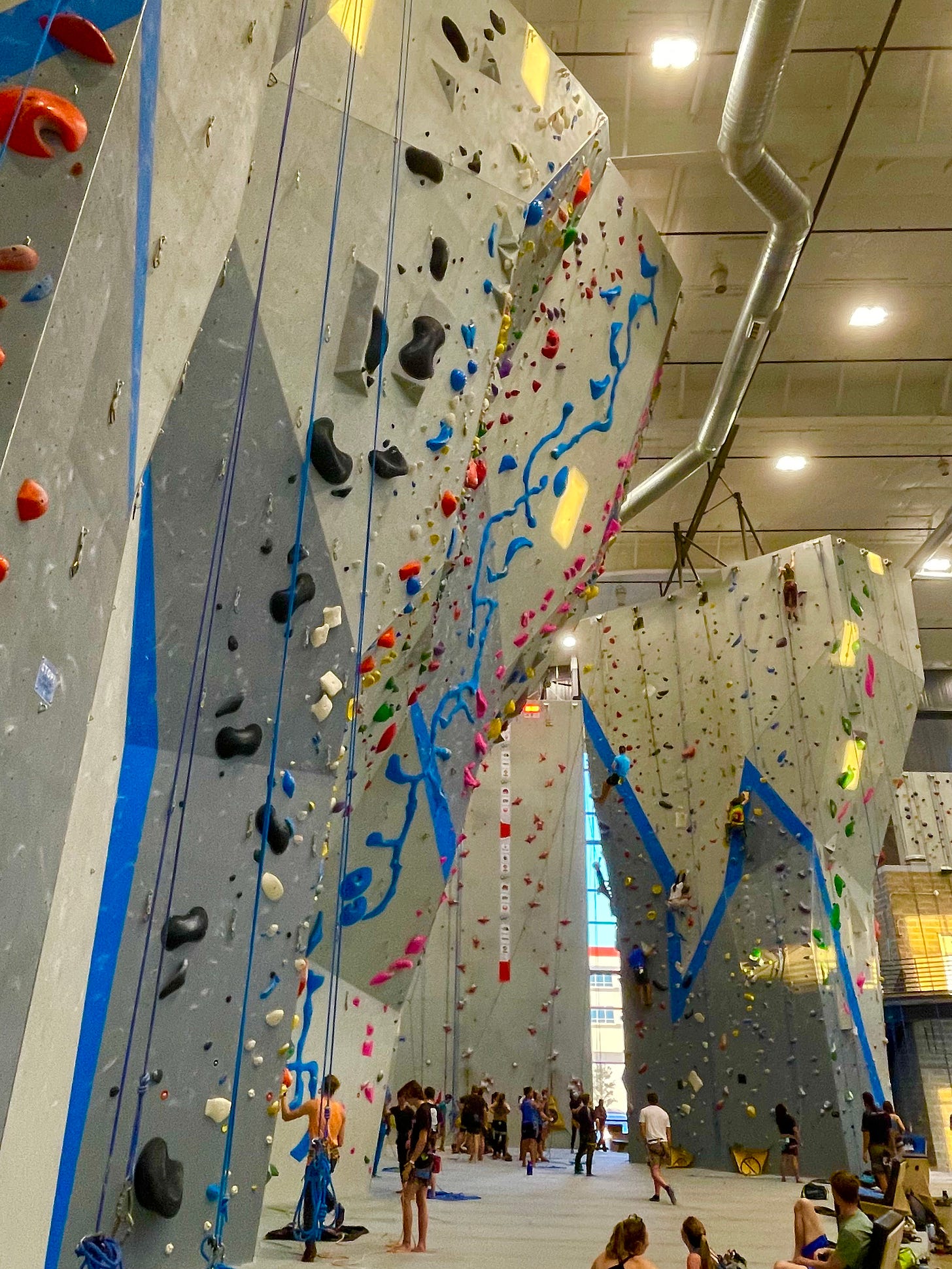 The walls of a rock gym with different colored holds