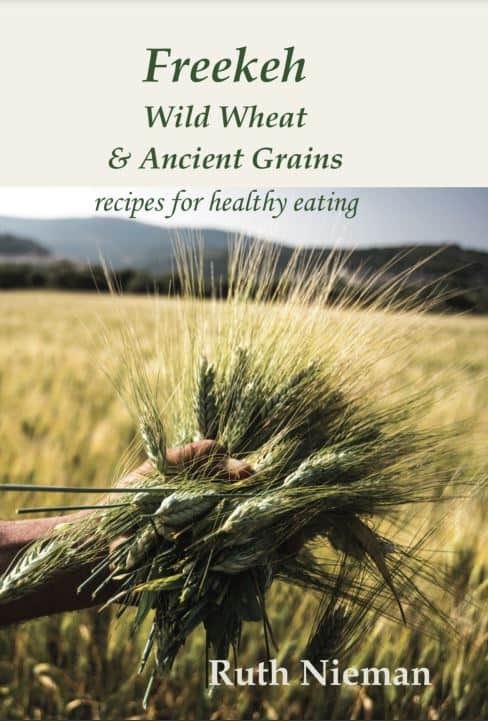 Cover of the book Freekeh, Wild Wheat & Ancient grains, recipes for healthy eating. Shows a hand holding ancient wheat.