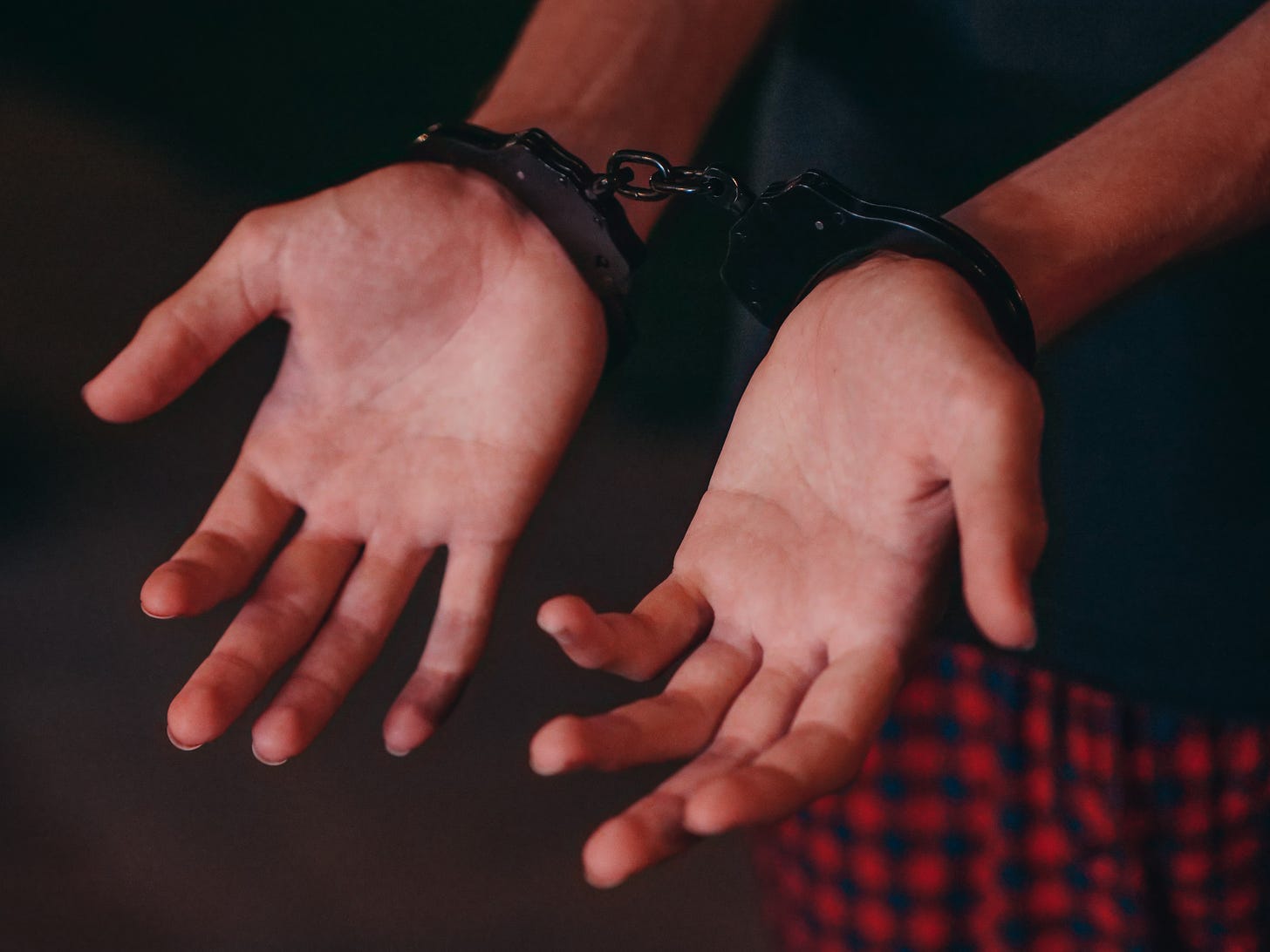 A person wearing handcuffs.