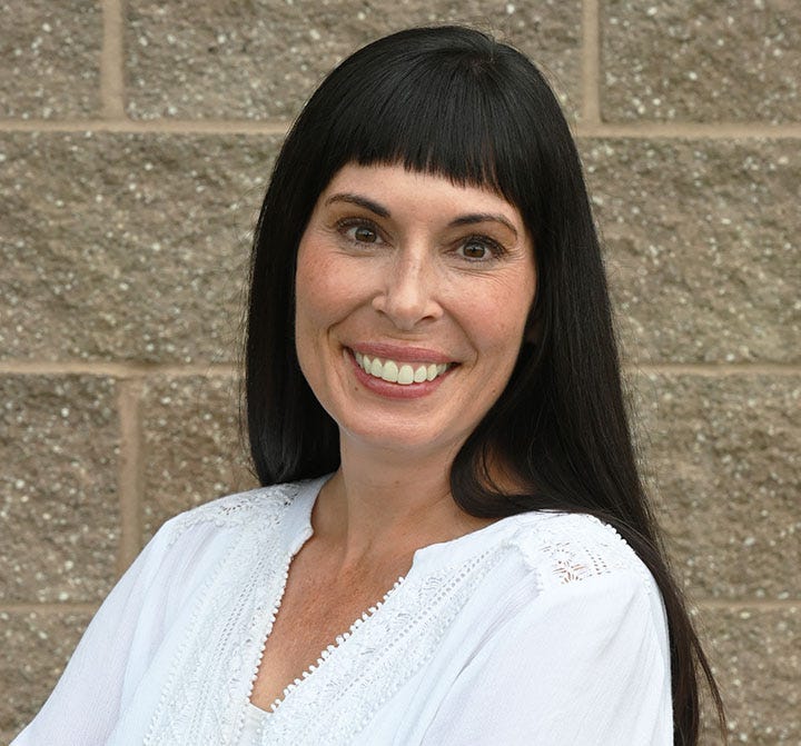 smiling white woman with black hair