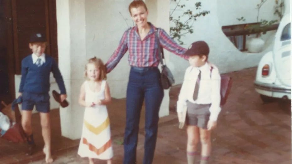 Kimbal, Tosca, and Elon Musk (Right) pose with their mother, Maye, before school in a childhood photo.