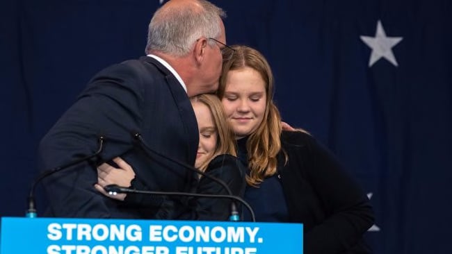 Mr Morrison embraces daughters Abbey and Lily.  Picture: Jason Edwards