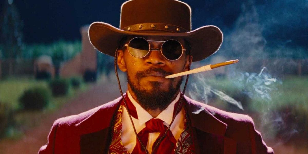 This image shows Django Freeman (played by Jamie Foxx) dressed in cowboy finery and smoking a cigarillo held in a long holder at the conclusion of Quentin Tarantino's 2012 film Django Unchained. This image shows Django Freeman (played by Jamie Foxx) dressed in cowboy finery and smoking a cigarillo held in a long holder at the conclusion of Quentin Tarantino's 2012 film Django Unchained.