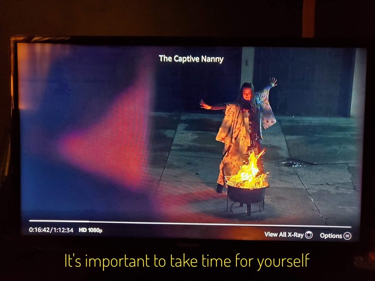 Chloe watching Emily dancing around a small fire bowl on a cracked concrete patio, captioned "It's important to take time for yourself"