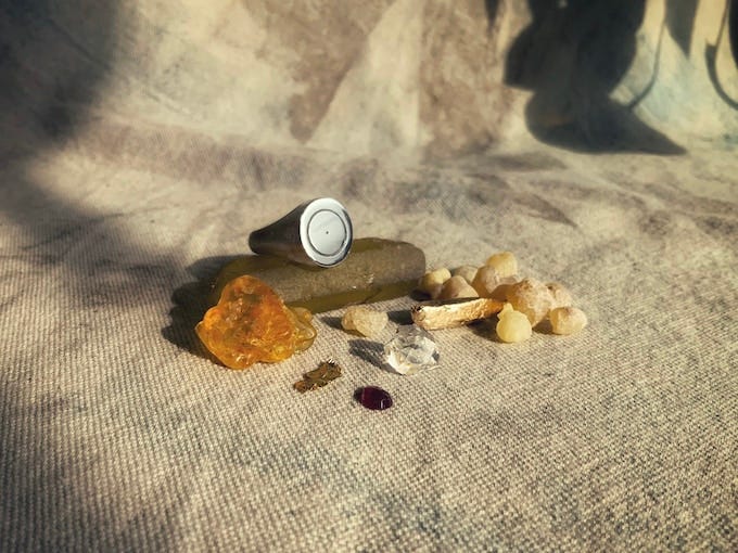 A still life of a silver ring in with frankincense, gold & gems