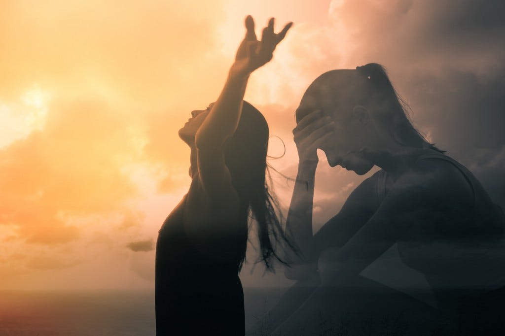 Photo courtesy of Shutterstock.com. Image of two women: one woman standing with her arms outstretched above her head, looking toward a sun-lit sky, and the other a figure in shadow, sitting with her head in her hand in front of a darker, cloudier sky.