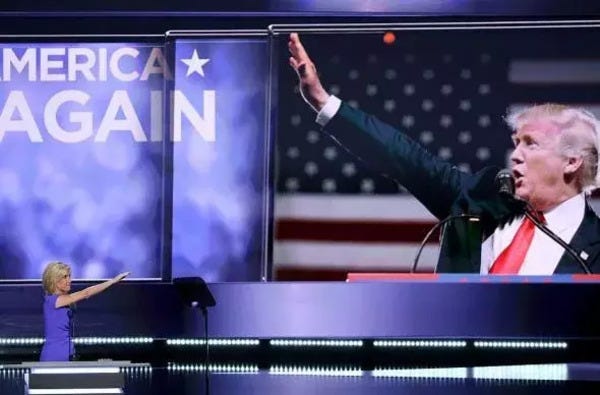 A still image of Laura Ingraham at the moment when at the end of her speech at the Republican National Convention she made a gesture indistinguishable from a Nazi Salute in the direction of a screen bearing the image of Donald Trump.
