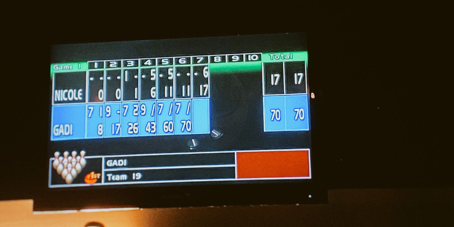 Photo of a bowling scoreboard, captured at turn #7. Nicole's score is 17. Gadi's score is 70.