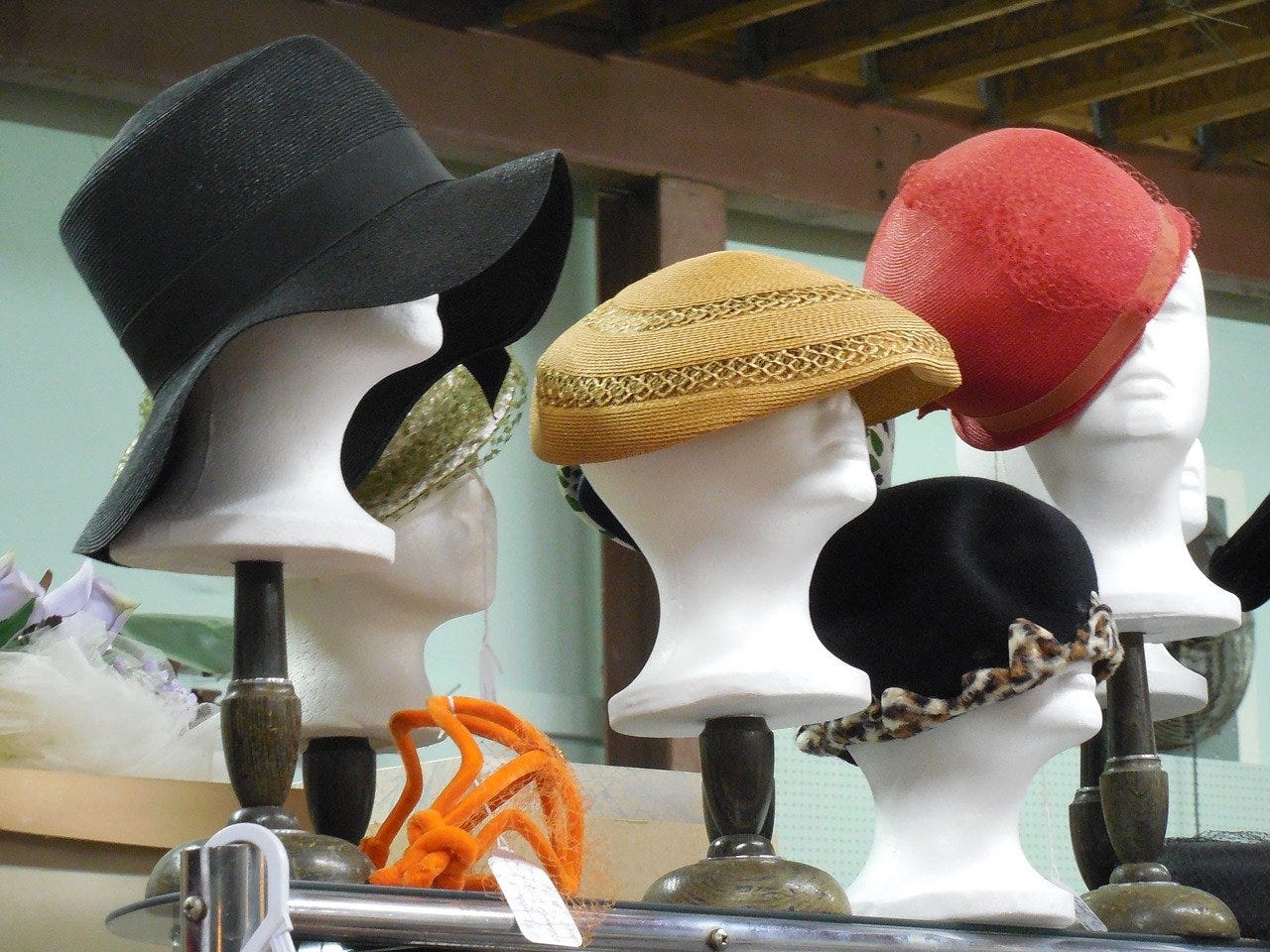 Mannequin heads with an assortment of hats