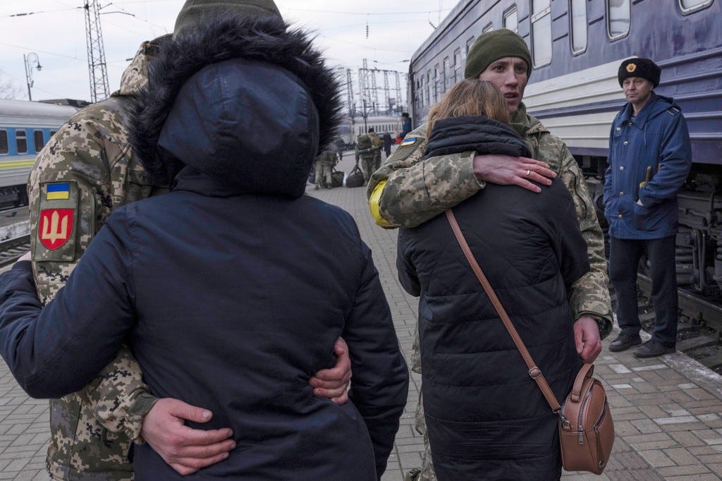 Couples embrace before leaving to help the war effort.