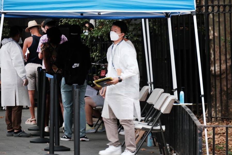 Healthcare workers with the New York City Department of Health and Mental Hygiene work at intake tents where individuals are registered to receive the monkeypox vaccine on July 29, 2022, in New York City. The World Health Organization has now declared that the monkeypox outbreak, which continues to grow globally, is a global emergency.