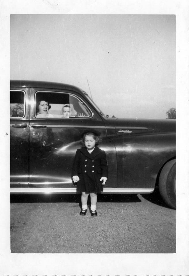 Cathy outside family's 1948 Chrysler Windsor while Helen and John look out passenger side window.