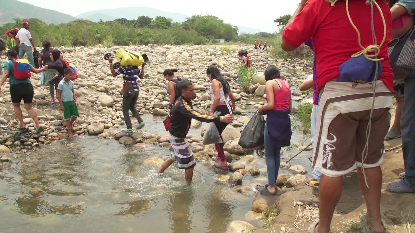People scramble across Colombia-Venezuela border with no evident control -  CNN Video