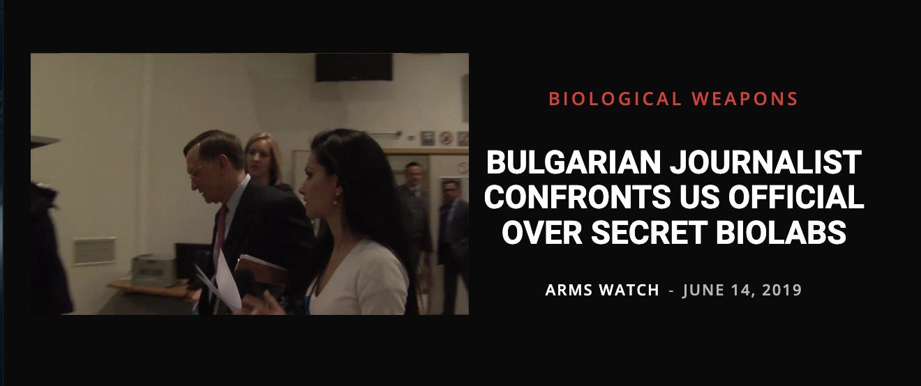 Image description: Black background, on left side is a picture of a several people in a room, a white woman in a white shirt in the foreground interviewing a white man next to her who is wearing a dark suit. There are people in the background watching them. On the right side is a headline in white text that reads: “Bulgarian journalist confronts US official over secret biolabs”. Below headline text reads: “Arms Watch — June 14, 2019”