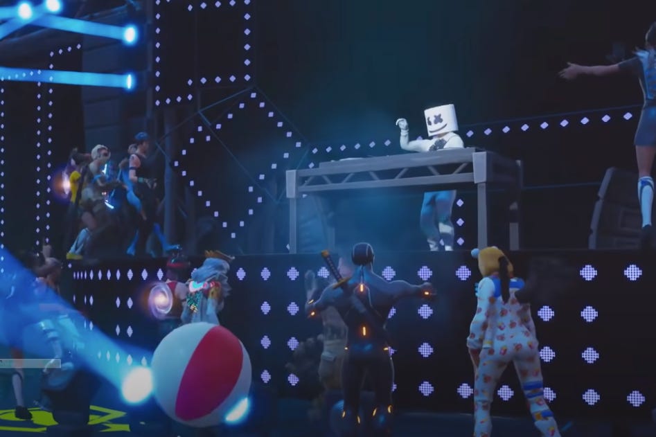 Imagem mostra cena como a de um videogame realista, com avatar do DJ Marshmello, atrás de mesa de mixagem, em um palco, e avatares de pessoas dançando, luzes e bolas na pista.