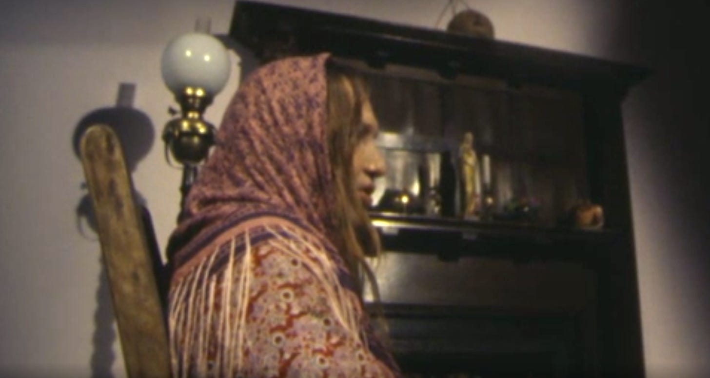 Still from an Irish television program showing a woman in traditional garb viewed from the side so her full face is not visible.
