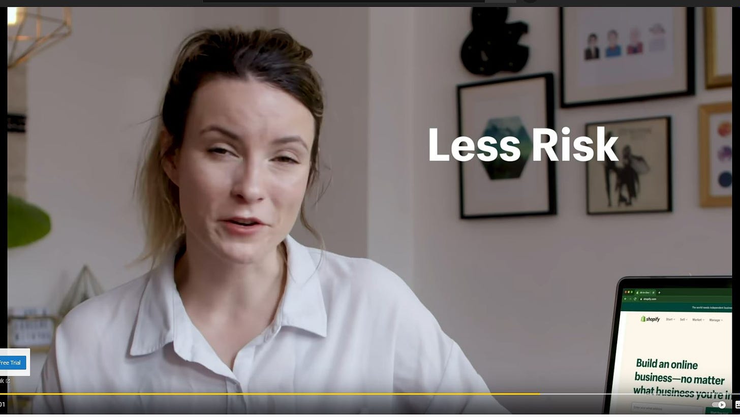 Taylin, mid-blink, sat next to a text overlay saying ‘Less Risk’. For whom? Whomst is the one partaking of lower quantities of risk, madam?
