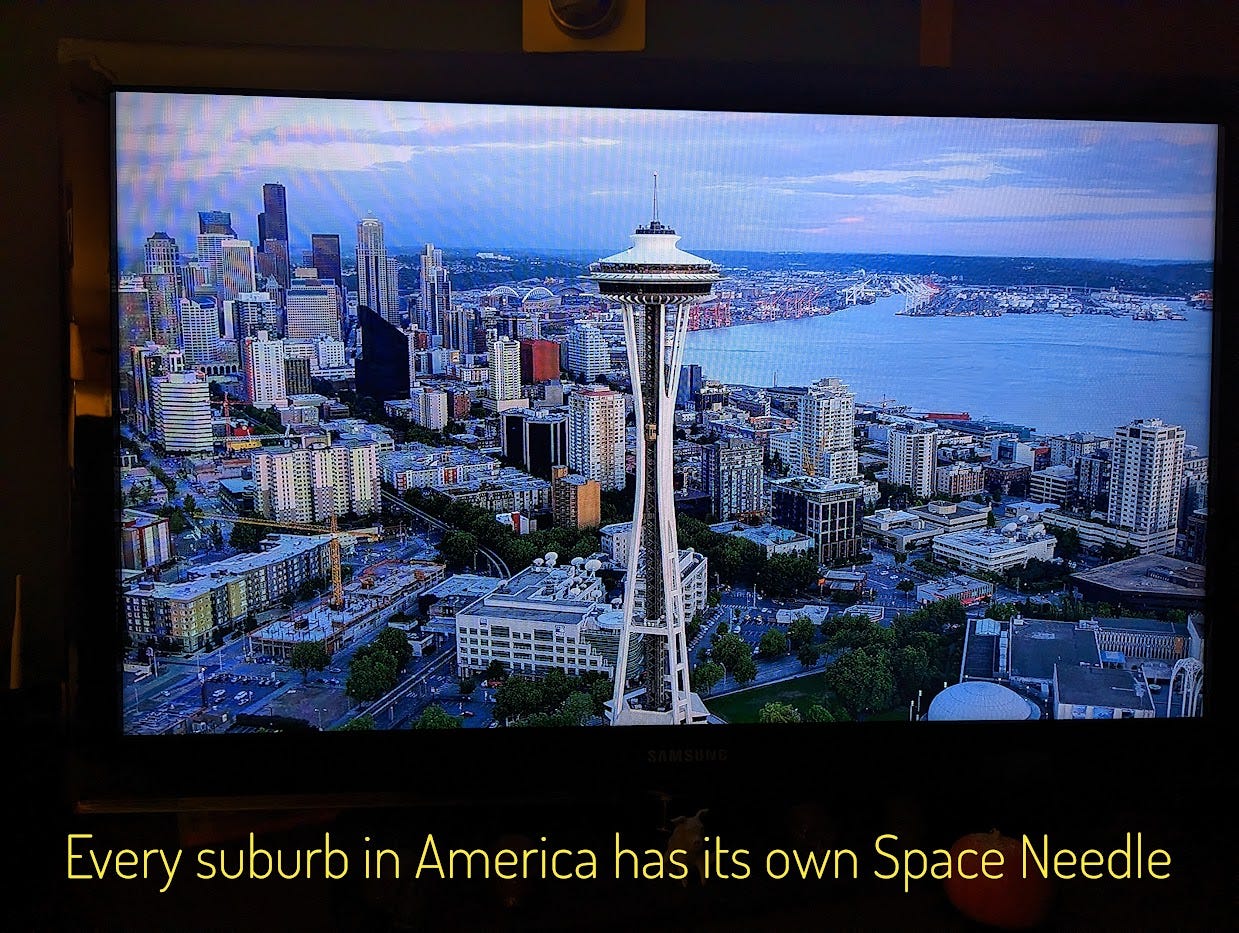 An establishing shot of the city of Seattle, with the Space Needle front and center. Captioned "Every suburb in America has its own Space Needle"