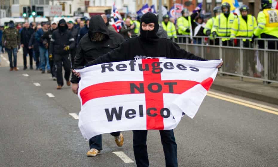 Racist pro-brexit supporter with banner saying "refugees not welcome"