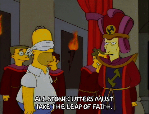 GIF of comic, Homer Simpson from The Simpsons, was blindfolded, in preparation to take the leap of faith, in some weird ritual. The caption of the GIF reads: All stonecutters must take the leap of faith.