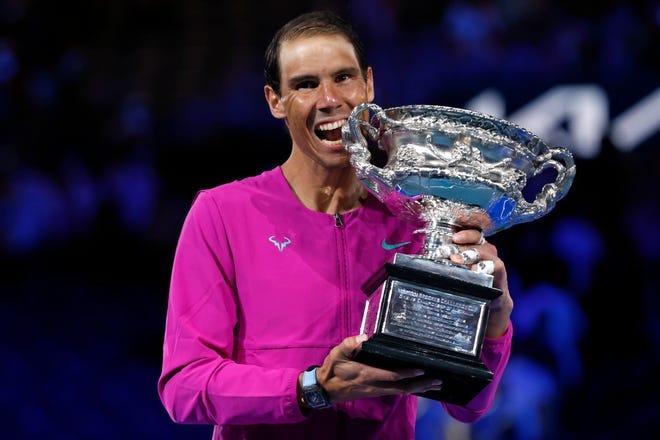 Rafael Nadal holds the Norman Brookes Challenge Cup after defeating Daniil Medvedev in five sets for his 21st career Grand Slam singles title.