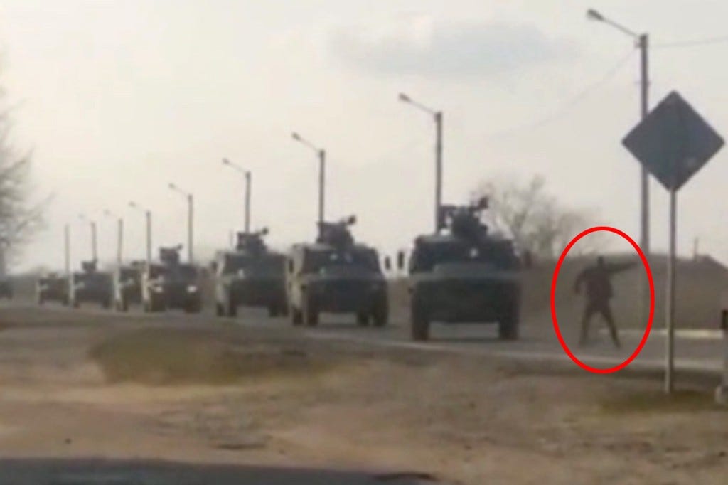 A man standing in front of a convoy of Russian military vehicles attempting to enter Kyiv.