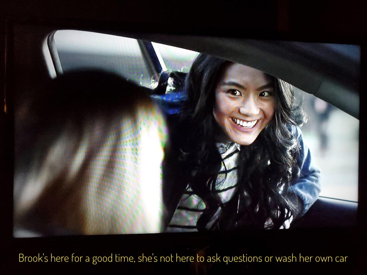 Brook grinning at Denise, captioned "Brook's here for a good time, she's not here to ask questions or wash her own car"