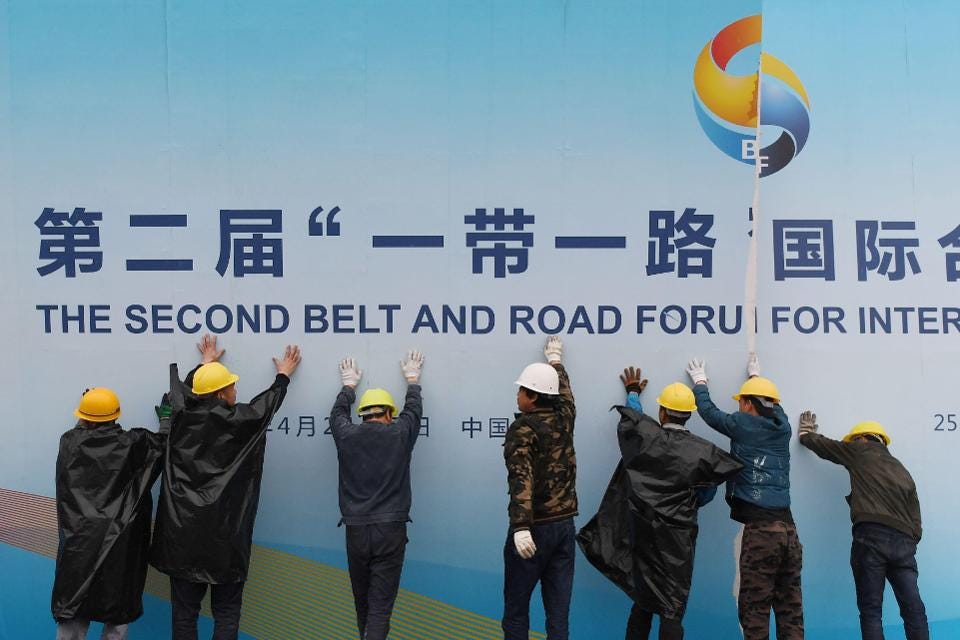 Workers take down a Belt and Road Forum panel.