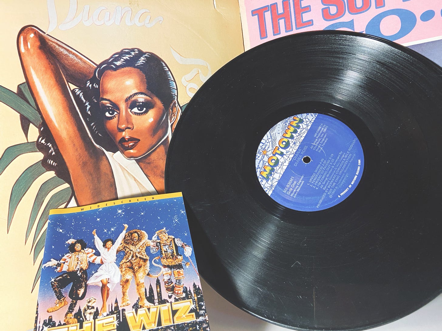 clockwise: Diana Ross' Ross album (1978), a peek of the Supremes A Go-Go record, the Diana (1980) vinyl, and the credits for The Wiz (1978).