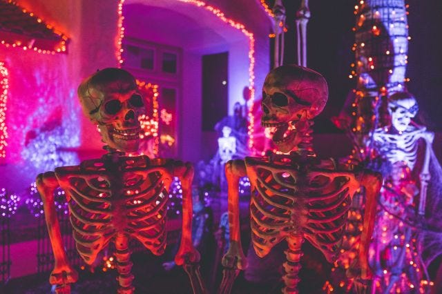 a photo of two skeletons who look like they're laughing