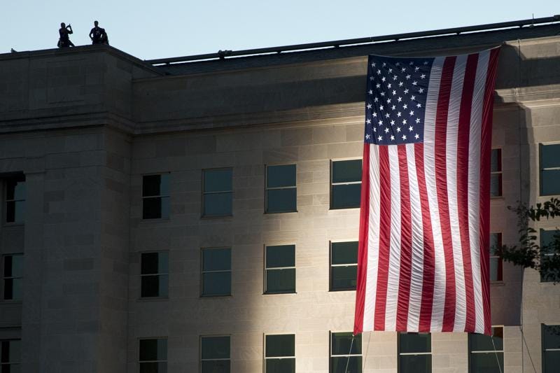 FILE - In this Sept. 11, 2015, file photo an American flag is draped on the side of the Pentagon where the building was attacked Sept. 11, 2001, on the 14th anniversary of the attack. As the 20th anniversary of the Sept. 11, 2001, terrorist attacks approaches, Americans increasingly balk at intrusive government surveillance in the name of national security, and only about a third believe that the wars in Afghanistan and Iraq were worth fighting, according to a new poll by The Associated Press-NORC Center for Public Affairs Research. (AP Photo/Jacquelyn Martin, File)