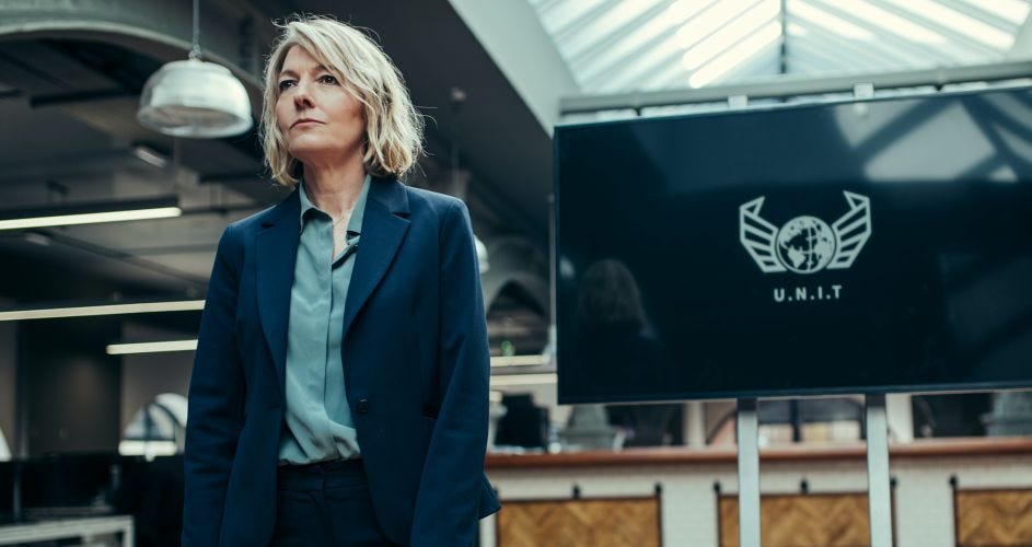 This image shows Kate Lethbridge-Stewart (played by Jemma Redgrave) standing before a UNIT plasma screen in Doctor Who: Flux's fourth chapter (titled "Survivors of the Flux"). This image shows Kate Lethbridge-Stewart (played by Jemma Redgrave) standing before a UNIT plasma screen in Doctor Who: Flux's fourth chapter (titled "Survivors of the Flux").