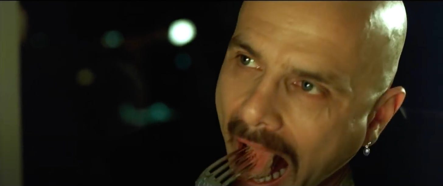 Still from the film "The Matrix" where character Cypher eats a piece of steak