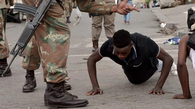 A man is forced to do push-ups by members of the SANDF in Alexandra township in Gauteng at the weekend.  Picture: Oupa Mokoena/African News Agency (ANA)
