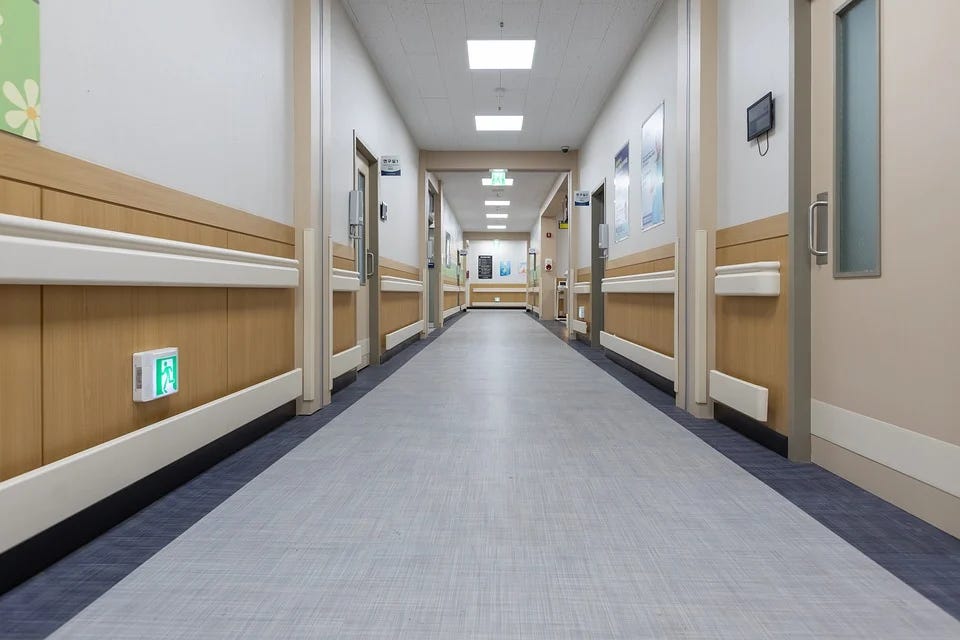 A long hospital hallway, empty